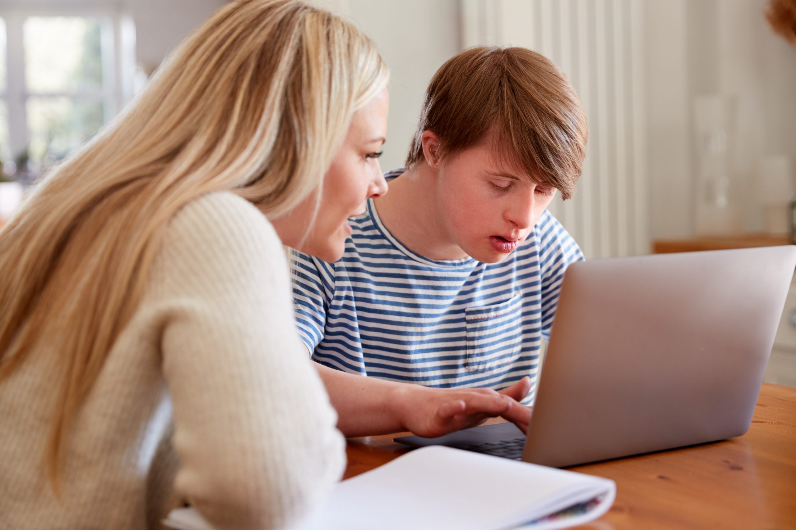 man and woman using a computer at table